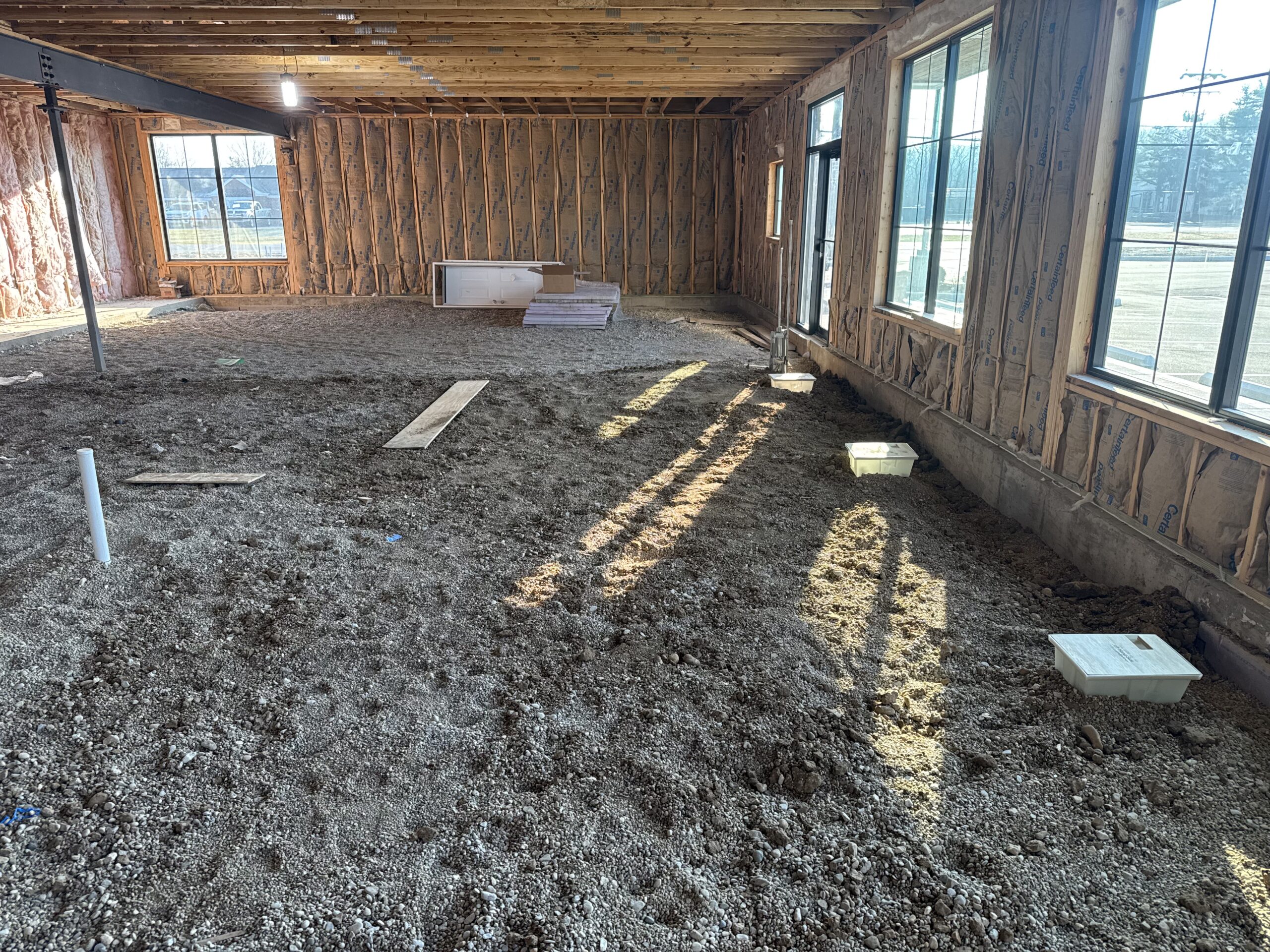 Dirt floor of Harrison with walls.