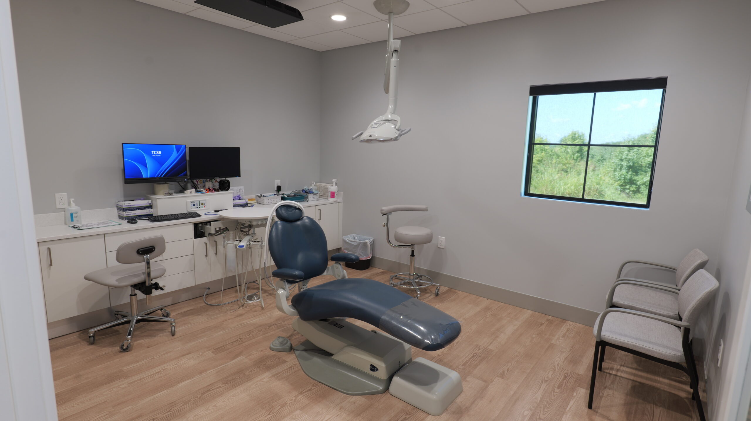 Dental room with chair, over head light and tools
